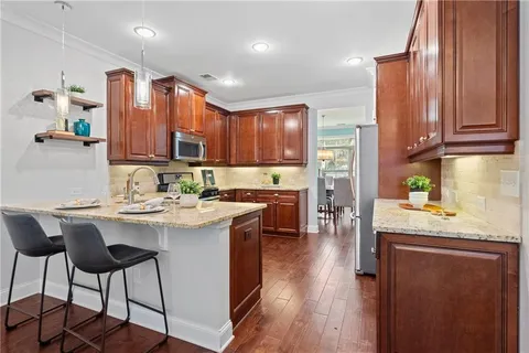 a kitchen with a sink refrigerator and cabinets