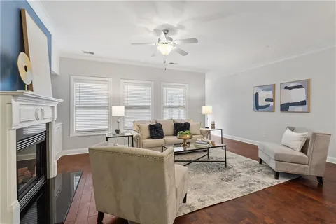 a living room with furniture a fireplace and a flat screen tv