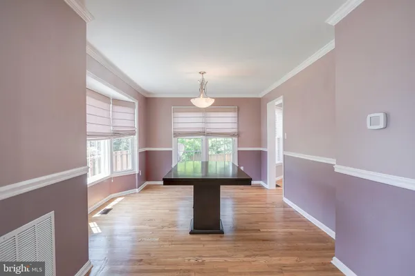 a room with pool table mirror and windows