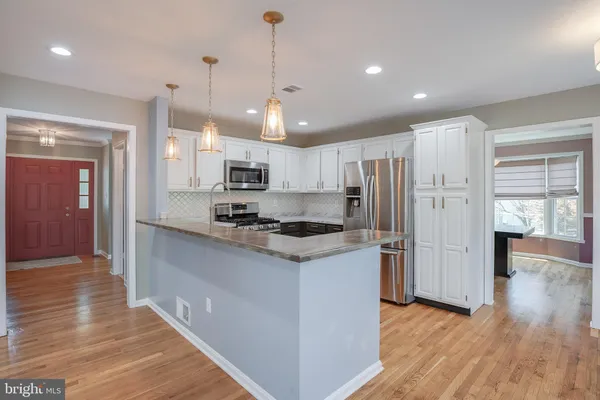 a kitchen with stainless steel appliances a refrigerator stove and microwave