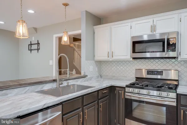 a kitchen with center island and windows