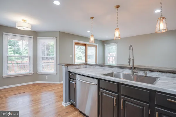 a view of kitchen with wooden floor and windows