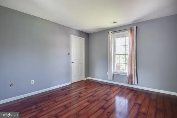 a view of room with wooden floor