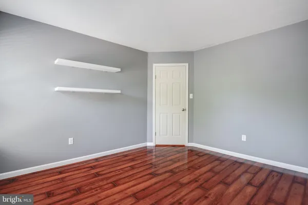 a view of an empty room and wooden floor