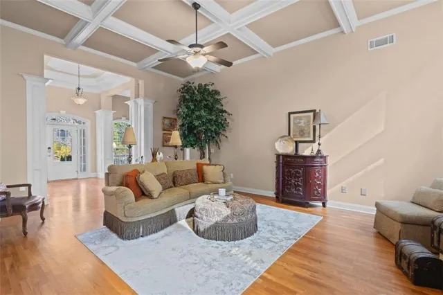 a living room with furniture and a chandelier