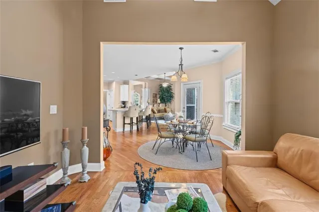 a dining room with furniture and wooden floor