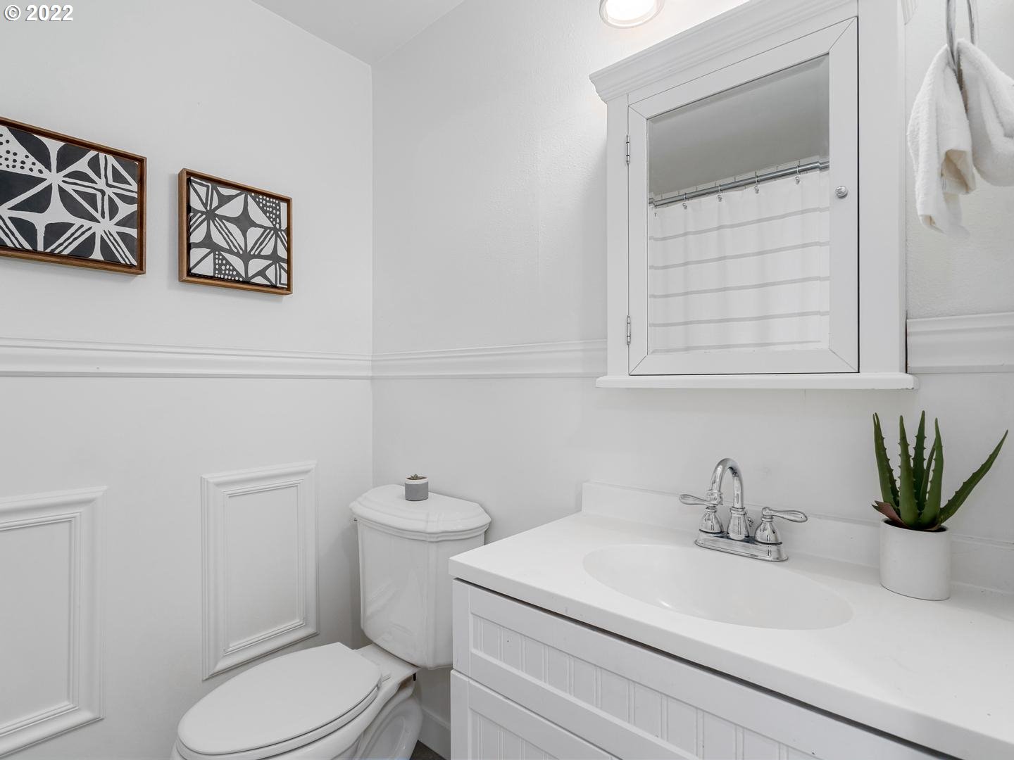 3200 Southeast Loeffelman Road Milwaukie, OR 97222 - Photo 20 of 32 a bathroom with a sink a toilet and a mirror