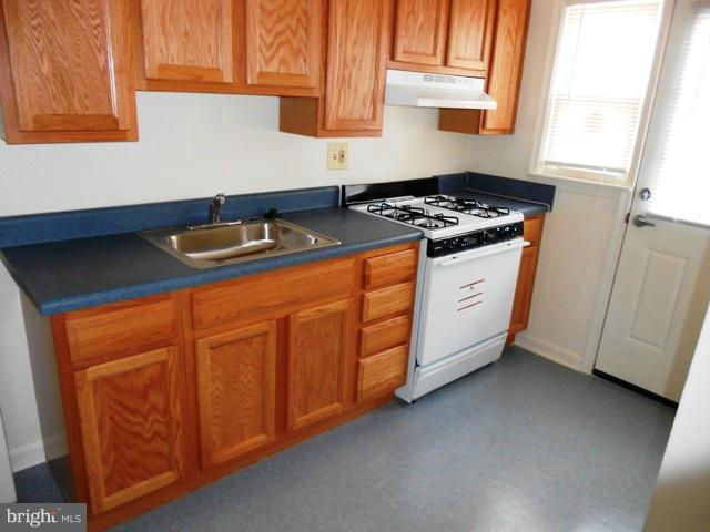 2034 Jasmine Road Dundalk, MD 21222 - Photo 8 of 23 a kitchen with granite countertop sink cabinets and window
