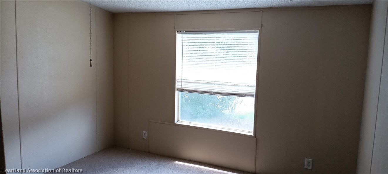 1026 Cardinal Road Wauchula, FL 33873 - Photo 11 of 12 a view of an empty room with a window