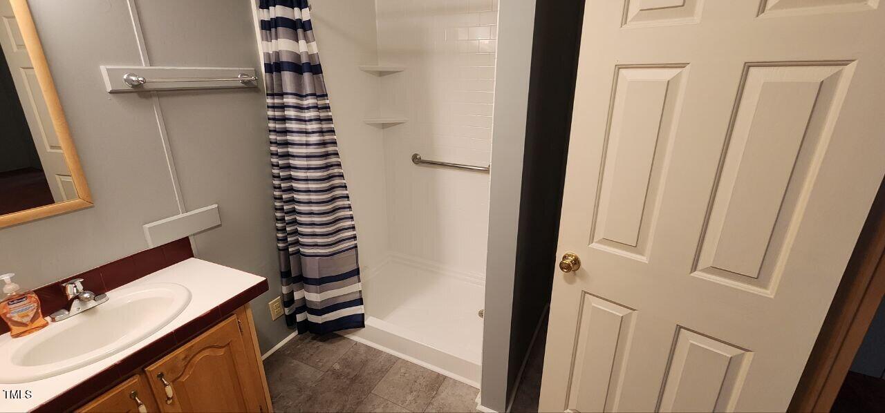 4470 Thomas Road Henderson, NC 27537 - Photo 14 of 21 a bathroom with a sink and a mirror