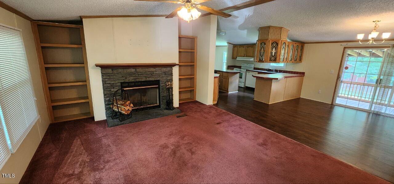 4470 Thomas Road Henderson, NC 27537 - Photo 9 of 21 a view of a kitchen with furniture and a fireplace