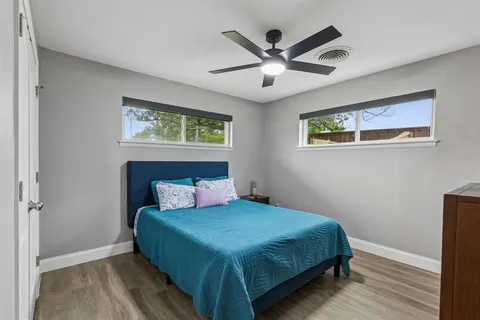 a bedroom with a large bed and a chandelier