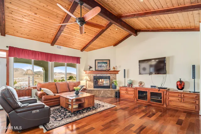 a dining room with furniture a chandelier and wooden floor