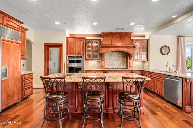 a spacious bathroom with a granite countertop tub sink and mirror