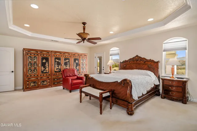 a bathroom with a granite countertop sink a toilet a mirror and shower