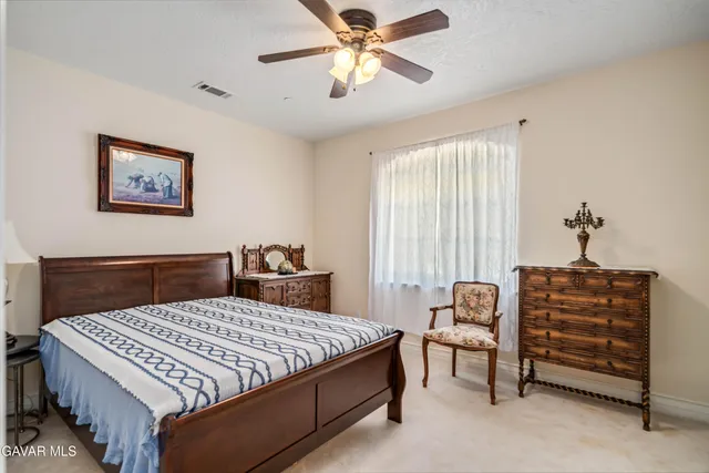 a view of a white house with wooden fence