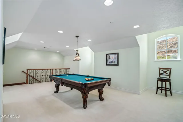 a view of a hallway with wooden floor and windows