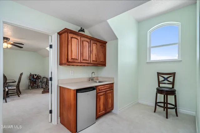 a bathroom with a granite countertop sink a toilet and a mirror