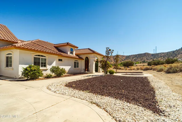 a living room with fireplace furniture and a wooden floor