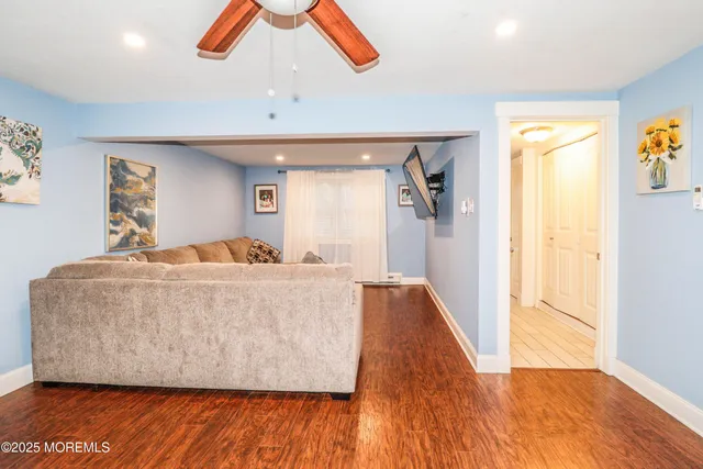 a living room with wooden floor and furniture