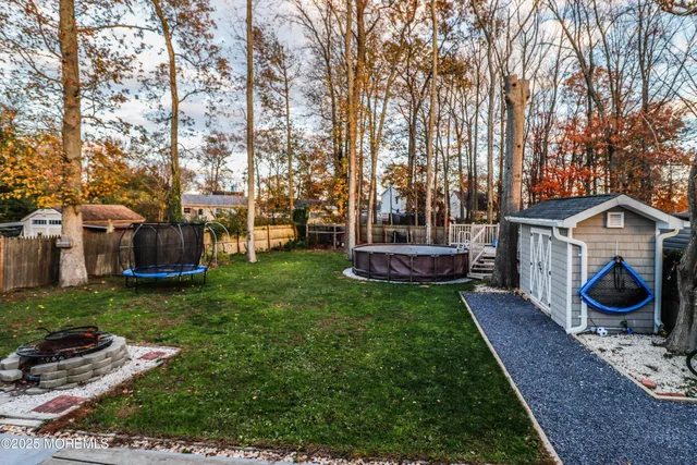 a view of a backyard with sitting area and trees