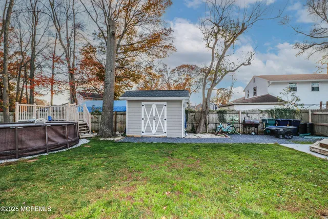 a view of a house with a yard and sitting area