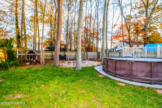 a view of yard with swimming pool and trees