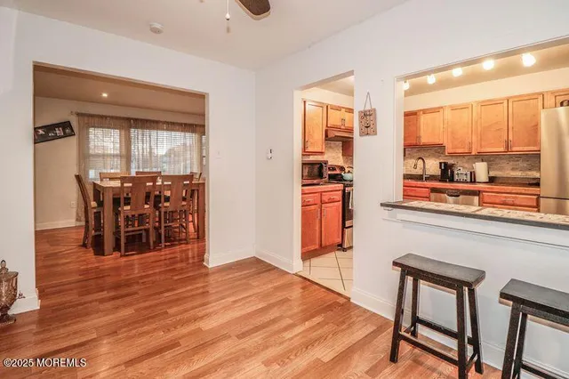 a living room with wooden floor and furniture