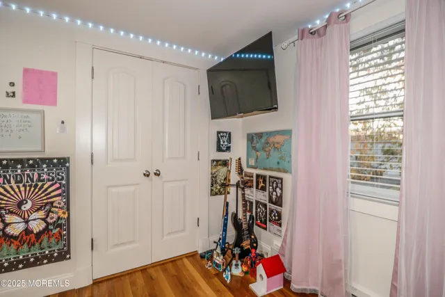 a view of a livingroom with wooden floor and a window