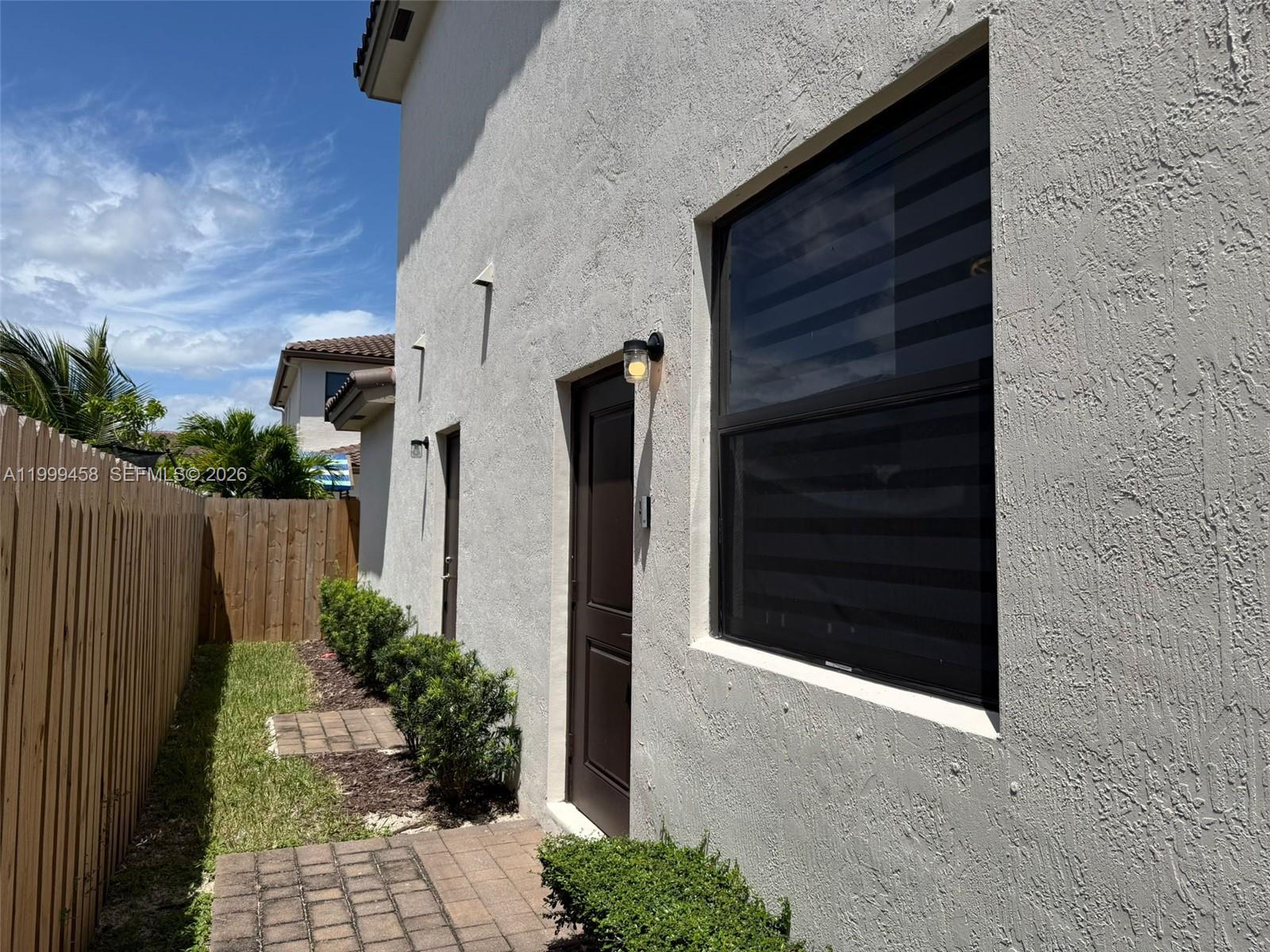 11909 Southwest 244th Street, Unit EFFICIENCY Homestead, FL 33032 - Photo 2 of 11 a couple of potted plants in front of door