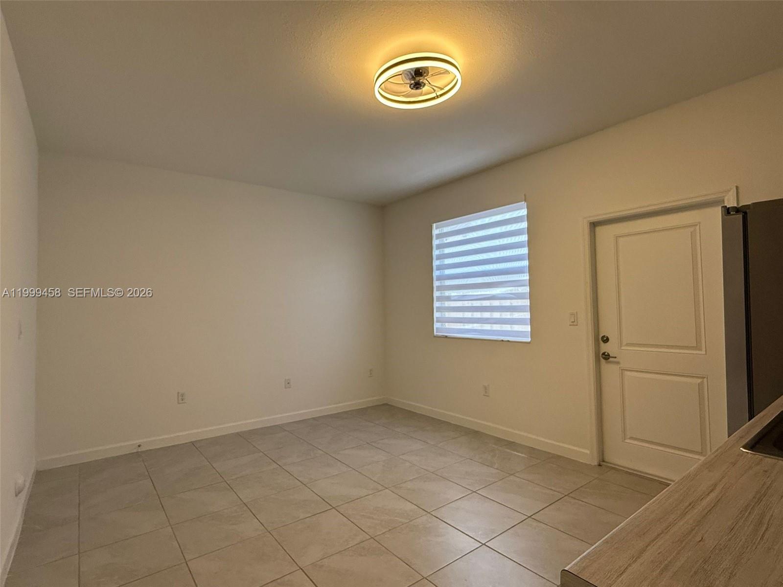 11909 Southwest 244th Street, Unit EFFICIENCY Homestead, FL 33032 - Photo 5 of 11 an empty room with windows
