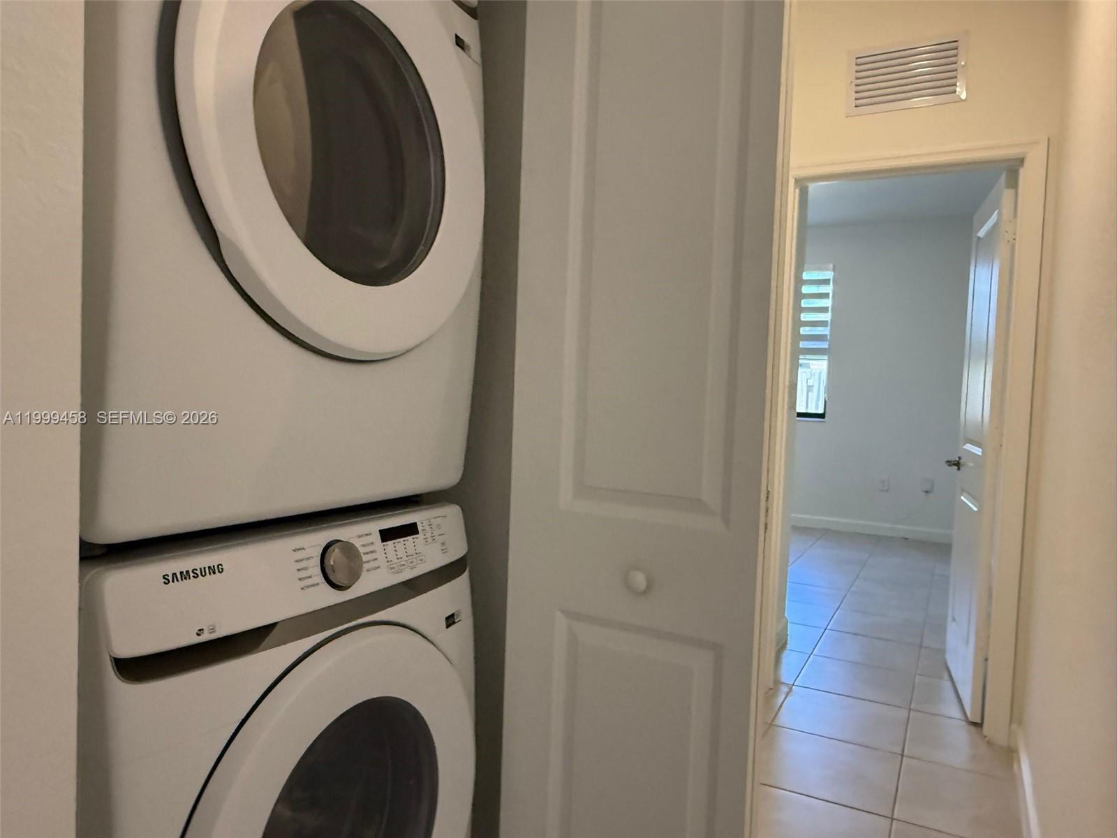 11909 Southwest 244th Street, Unit EFFICIENCY Homestead, FL 33032 - Photo 6 of 11 a view of a hallway with washer and dryer