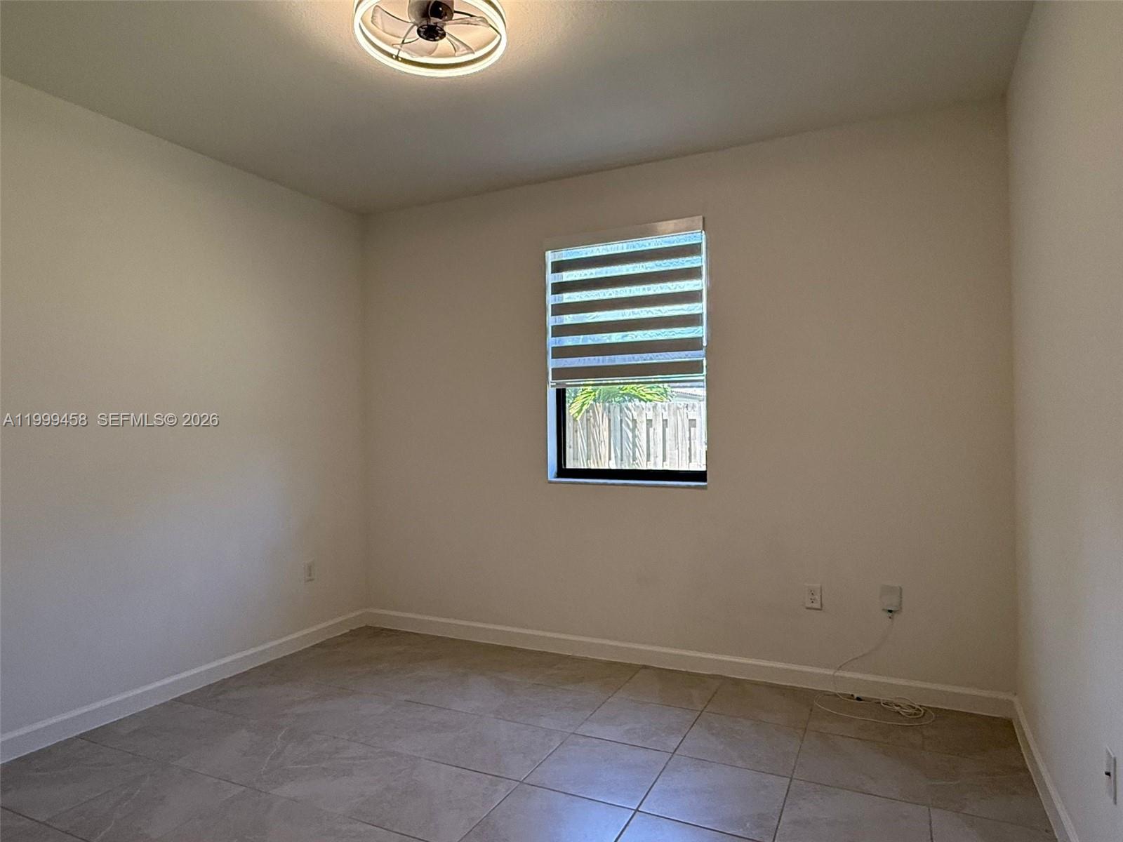 11909 Southwest 244th Street, Unit EFFICIENCY Homestead, FL 33032 - Photo 8 of 11 a view of an empty room with a window