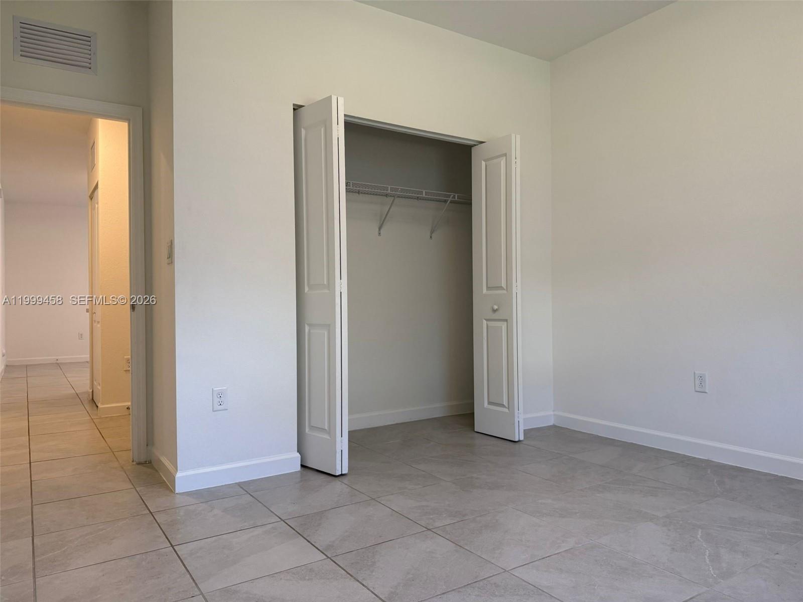 11909 Southwest 244th Street, Unit EFFICIENCY Homestead, FL 33032 - Photo 9 of 11 an empty room with closet