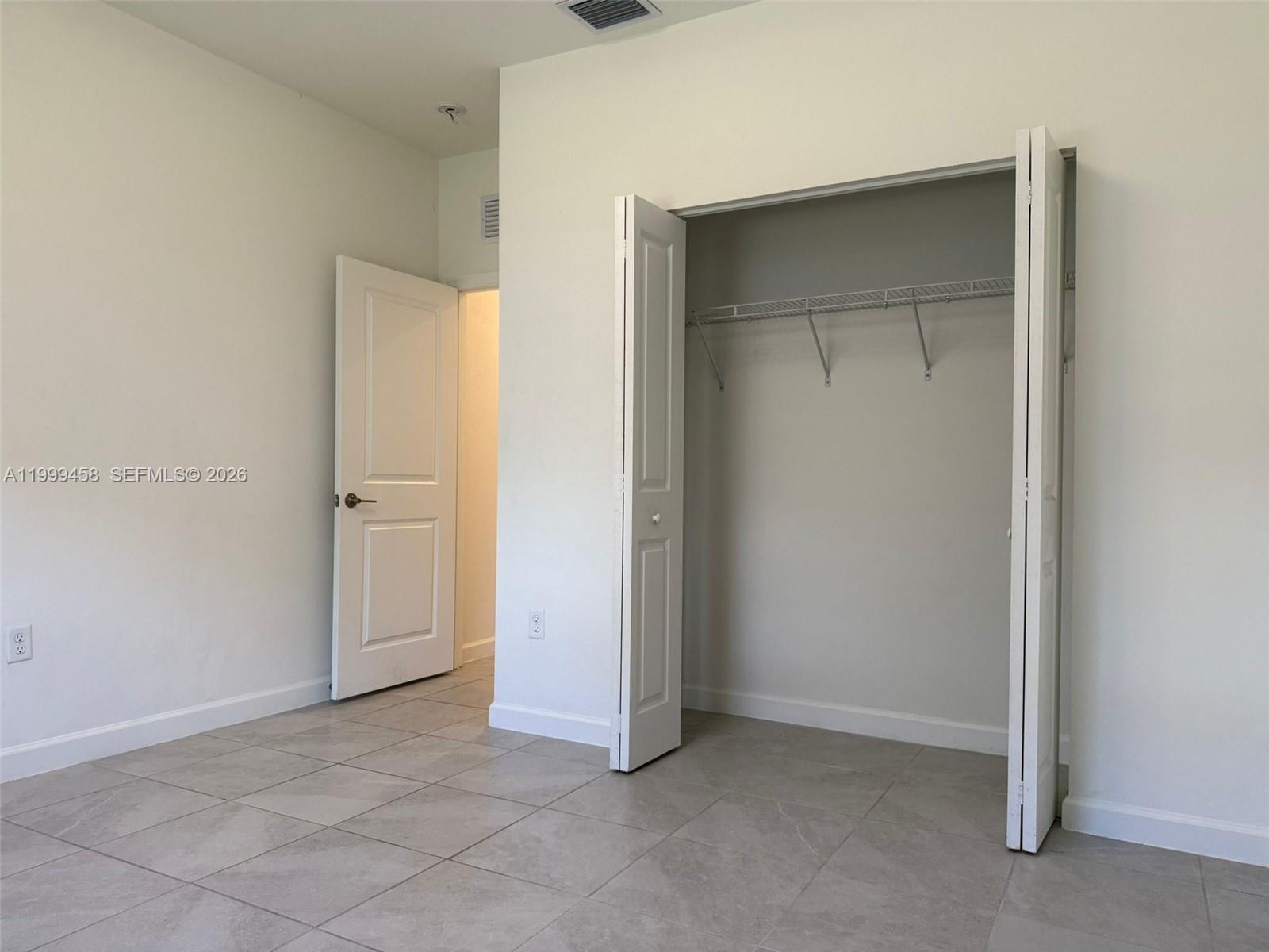 11909 Southwest 244th Street, Unit EFFICIENCY Homestead, FL 33032 - Photo 10 of 11 an empty room with closet