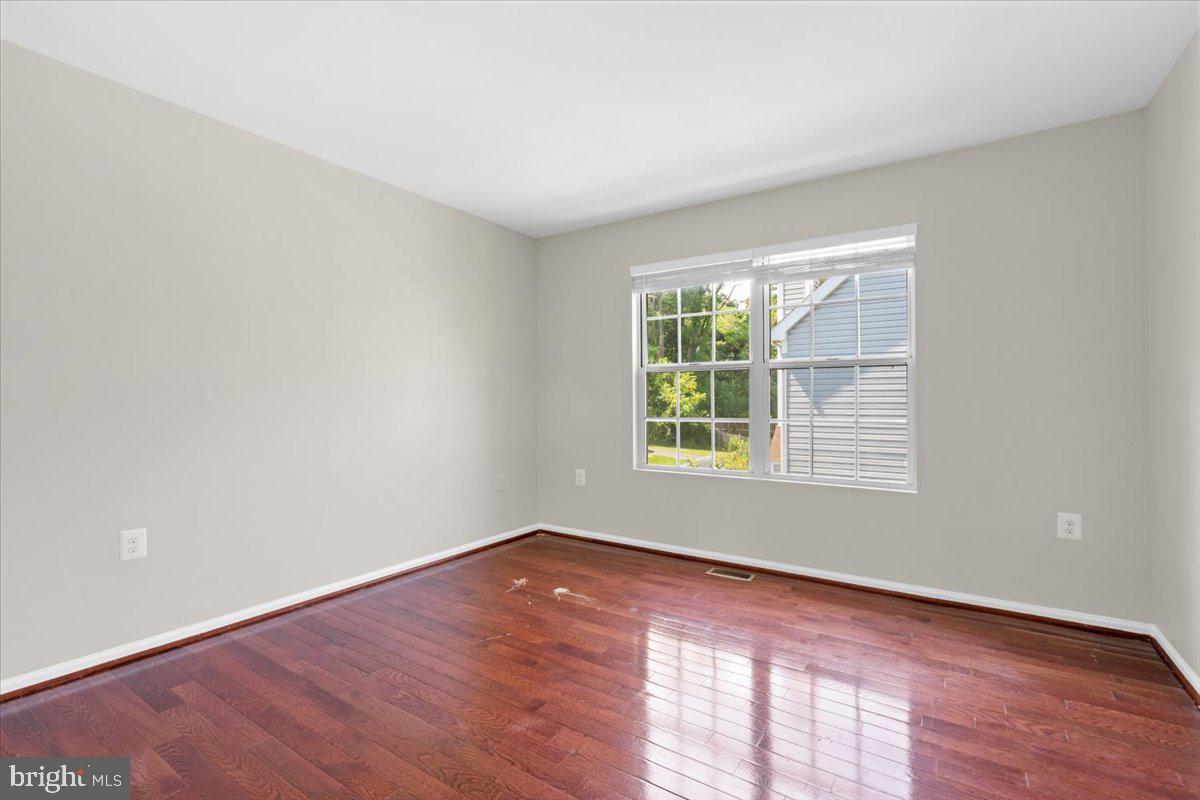 461 Foxridge Drive Southwest Leesburg, VA 20175 - Photo 16 of 25 an empty room with wooden floor and windows