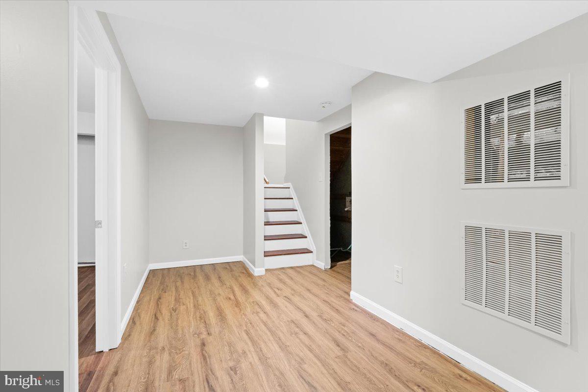 461 Foxridge Drive Southwest Leesburg, VA 20175 - Photo 19 of 25 a view of room with stairs and wooden floor