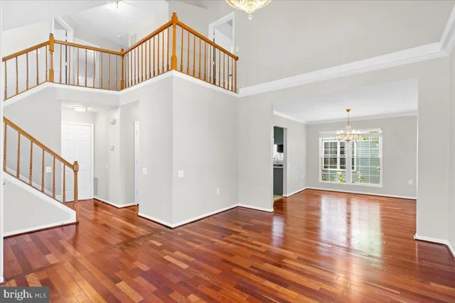 a view of an entryway wooden floor and a window