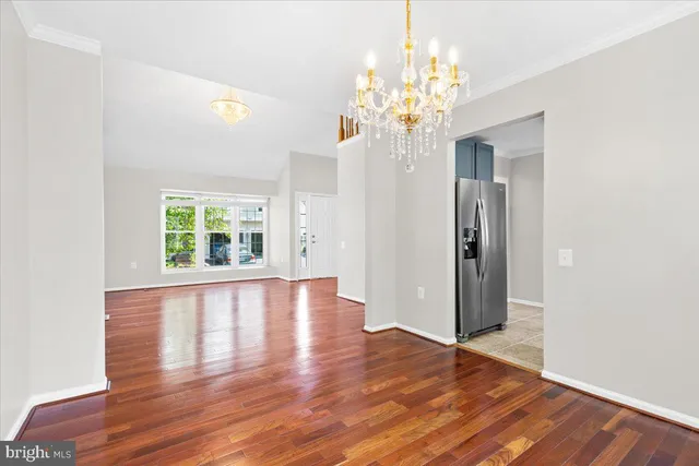 a view of a room with wooden floor and large windows