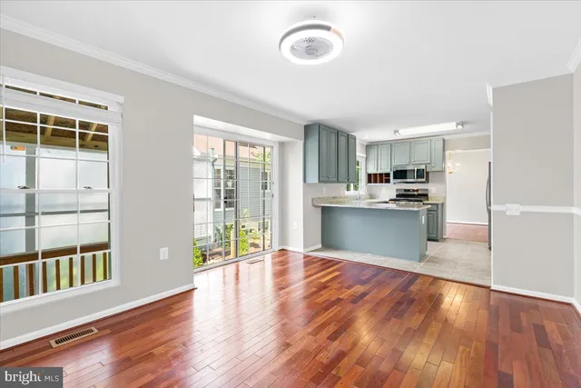 a view of a kitchen with wooden floor and a kitchen