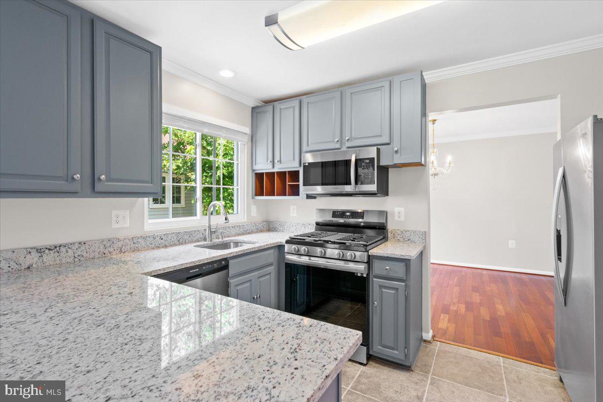461 Foxridge Drive Southwest Leesburg, VA 20175 - Photo 9 of 25 a kitchen with stainless steel appliances granite countertop a sink stove and refrigerator