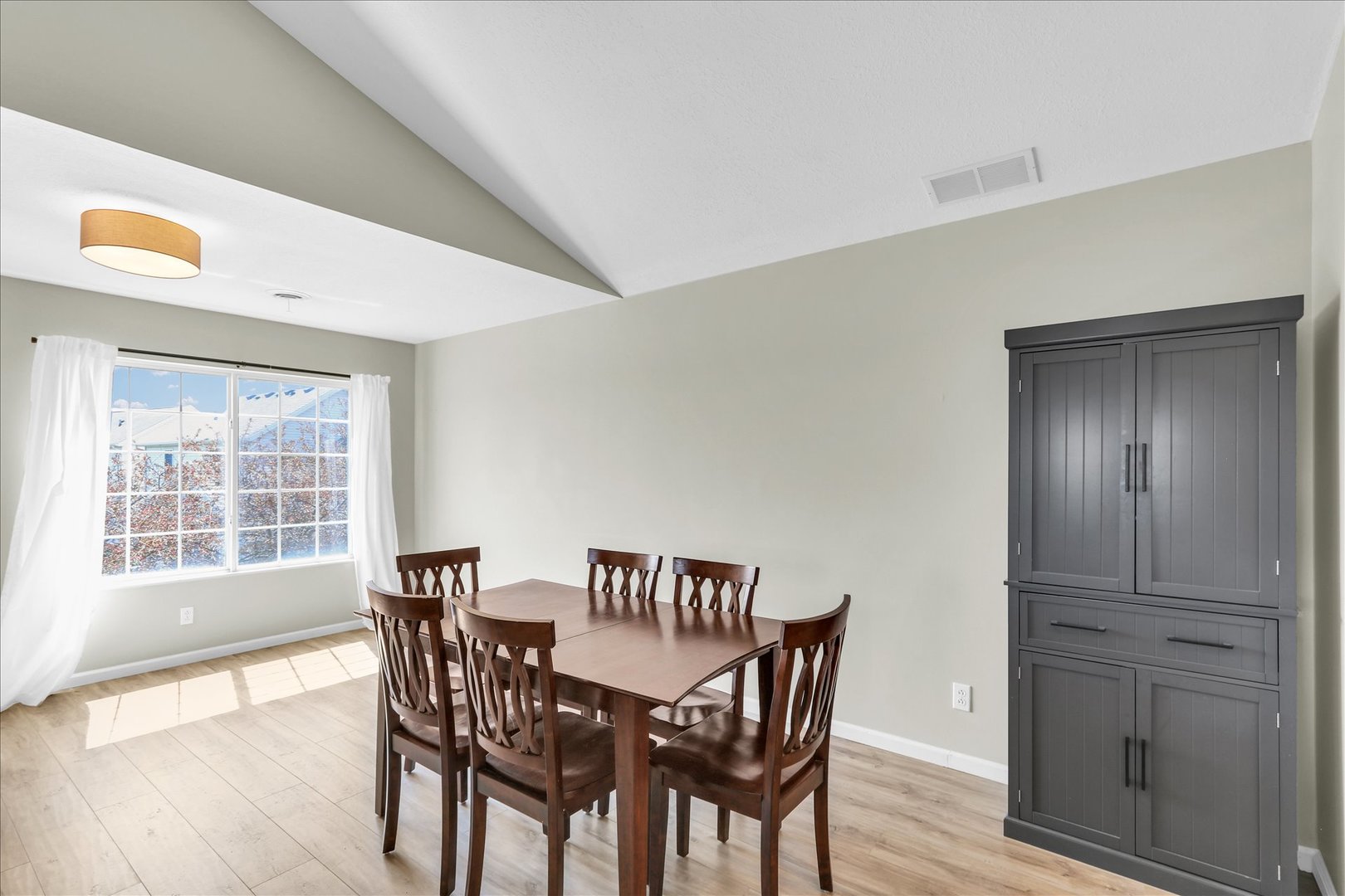 2402 Windward Boulevard, Unit 209 Champaign, IL 61821 - Photo 11 of 33 a view of a dining room with furniture and wooden floor