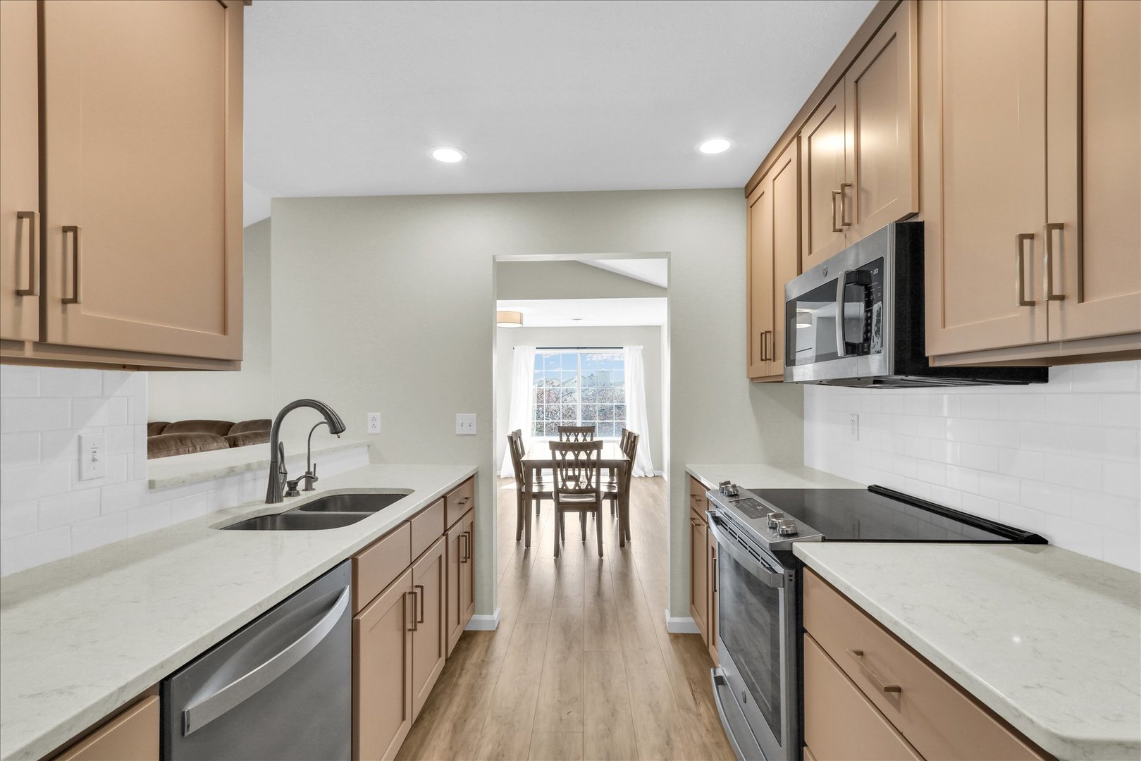 2402 Windward Boulevard, Unit 209 Champaign, IL 61821 - Photo 17 of 33 a kitchen with a sink cabinets and stainless steel appliances