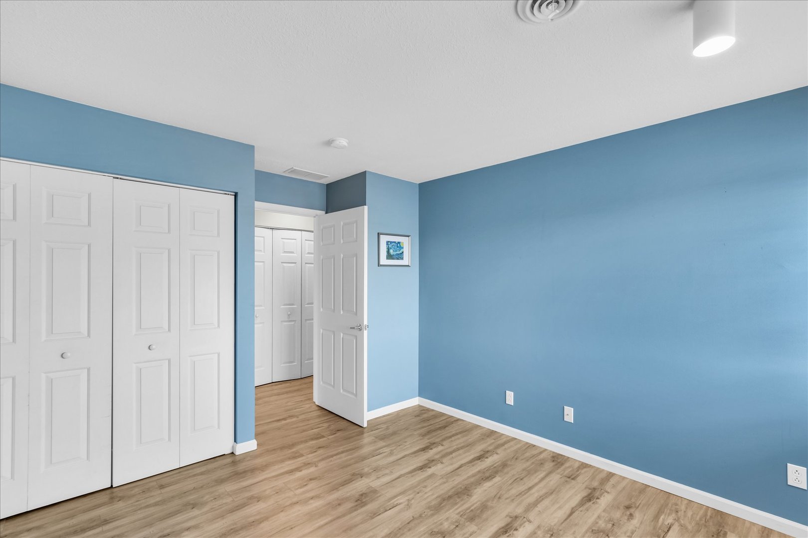 2402 Windward Boulevard, Unit 209 Champaign, IL 61821 - Photo 19 of 33 a view of an empty room with wooden floor