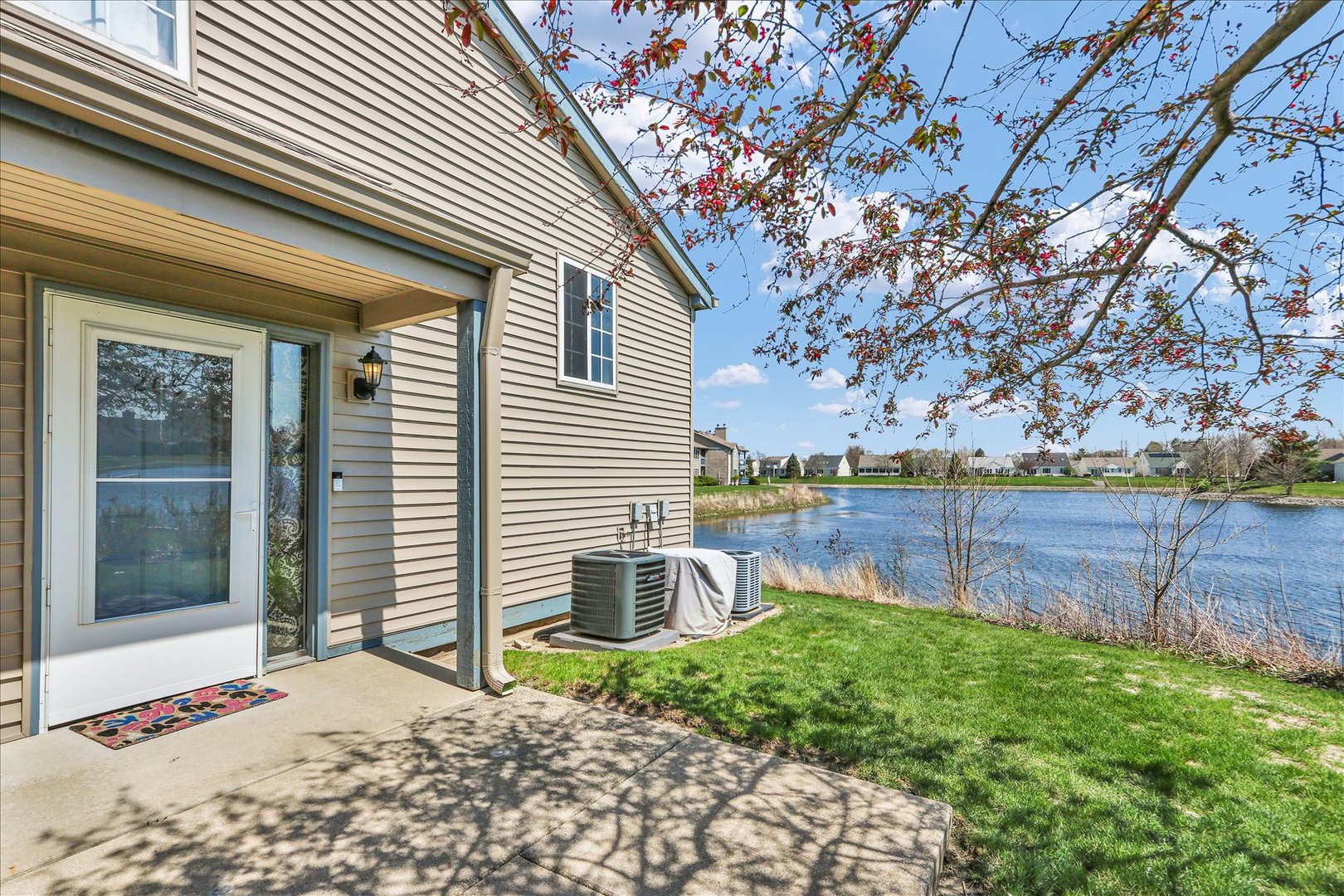 2402 Windward Boulevard, Unit 209 Champaign, IL 61821 - Photo 4 of 33 a backyard of a house with lots of green space