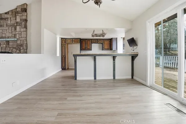 a view of a hallway with a white walls and a bathroom with a sink