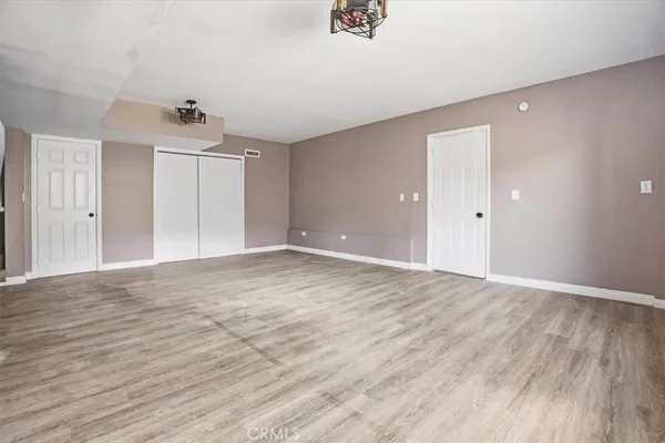 a white toilet sitting next to a white wall