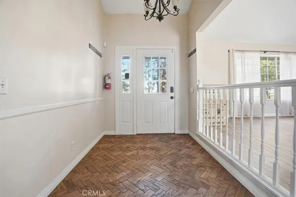 an empty room with windows and fireplace