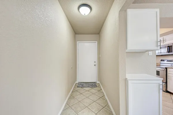 a view of a hallway with washer and dryer