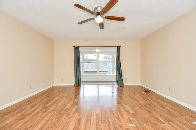 wooden floor in an empty room with a window